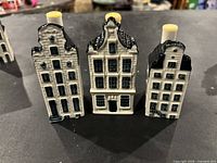 Front view of three porcelain KLM Delft Blue houses