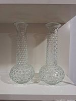 Both clear hobnail glass vases front view on shelf