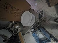 Stack of ten white dinner plates on cart