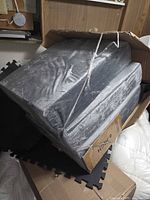 Mattress inside shipping carton, plastic wrap intact