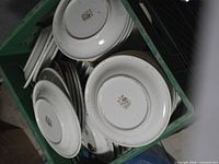Stacked white saucers underside visible with maker crest
