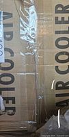 sealed shipping box marked AIR COOLER