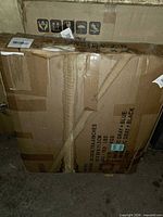 Sealed shipping carton containing dog house