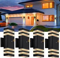 Four identical black outdoor wall sconces shown installed on house exterior at dusk