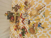 Full view of lot showing music box, rocking horses, houses, turned ornaments, clown and Pinocchio figures