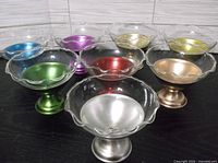 All eight sherbet cups showing assorted metallic bases and clear glass inserts