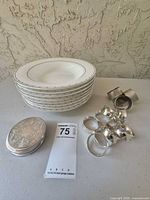 Stack of 8 bowls, 8 napkin rings, 4 coasters grouped on table