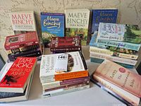 Full lot showing all paperback stacks on table