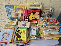 Front view of large stack showing various children’s books in mixed formats