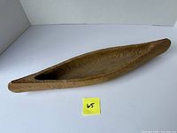 Top view of carved wooden canoe model