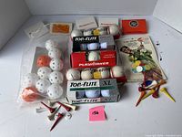 All items in lot: boxed golf balls, practice balls, tees, markers, matchbooks