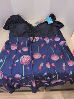 Full view of navy floral swimdress laid flat