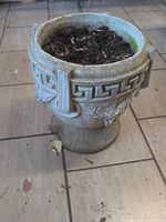 Front view of concrete urn showing Greek key band and fruit swag