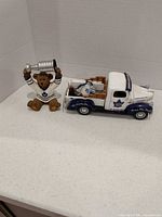 Group shot of bear figurine and die-cast truck
