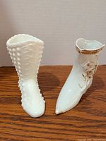 Front view of both boot figurines side by side