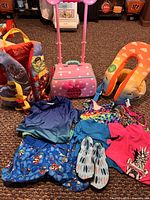 Group shot showing all swimwear items, flotation aids, Disney case