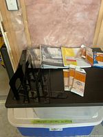 Overall lot with binders, paper packs, pencil packs and bookends on tray