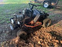 Driver side view of stripped Honda 3813 tractor showing engine, steering column, tires