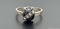 Front view of sterling silver ring showing cat’s eye cabochon and diagonal row of accent stones