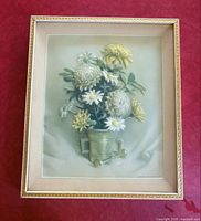 Front view of framed embroidered floral art in gold-tone frame