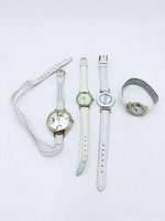 Full view of four women’s wristwatches laid out side by side