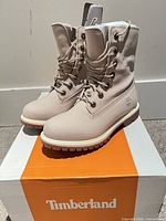 Three-quarter view of both boots on Timberland box