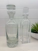 Both decanters side by side showing overall shapes and stoppers