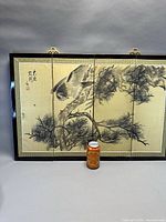 Front view of four-panel screen with soda can for scale