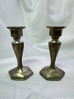 Pair of pewter candlesticks showing overall design and condition