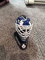 Front view showing mask graphics, cage and Maple Leafs base