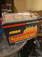 StarterLogg wood fire starter retail box front showing brand, quantity and damaged packaging