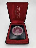 Open display case showing coin in holder