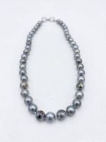 Full view of Tahitian pearl necklace laid flat