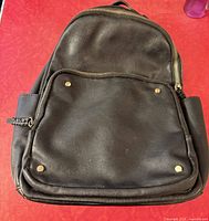 Front view showing overall design, front pocket, rivets, side pockets
