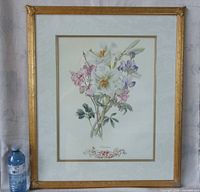 Full view of framed floral print with water bottle for scale