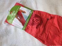 Front of packaged red Gaiam koi fish mat bag showing embroidery and zip pocket