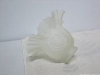 Side view of frosted glass lampshade highlighting oval motif and frilled rim