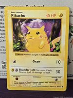 Front of Pikachu 58/102 card displaying artwork, attacks and red cheeks
