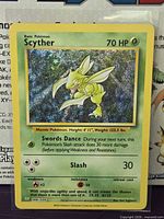 Front view of sleeved Scyther holo card showing holographic foil and card details