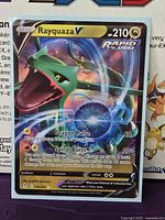 Front view of Rayquaza V card showing artwork and stats