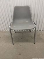 Front view of gray plastic stacking chair