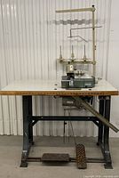 Full view of machine, table, motor, treadle, and thread stand