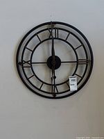 Full view of metal skeleton wall clock on wall