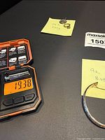 Digital scale showing 19.38 g pile of 10K pieces with sticky note references