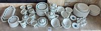 Full lot overview showing plates, bowls, cups, platters, teapots and accessories