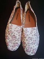 top view of both shoes showing unicorn print and overall condition
