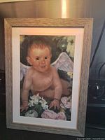 Full view of framed pastel painting showing cherub subject, mat, frame
