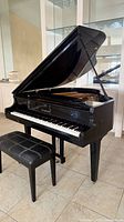 Hyundai baby grand piano with lid open and bench