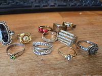 All twelve rings grouped on wooden surface