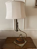 Full view of brass and wood desk lamp with shade